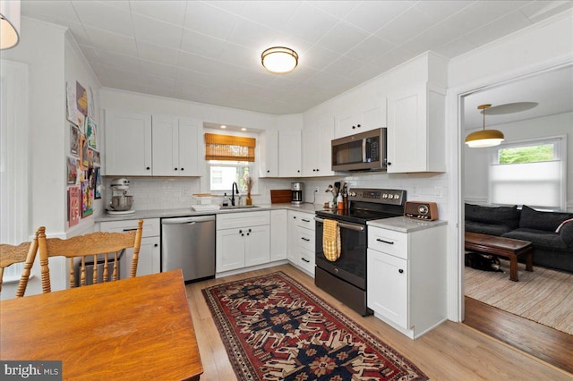1708 Wrightfield Rd, Yardley, PA 19067 - kitchen featuring stainless steel appliances, a sink, light wood-style flooring, white cabinetry, and light countertops