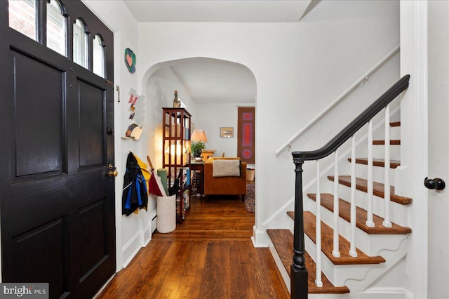 1708 Wrightfield Rd, Yardley, PA 19067 - entryway featuring arched walkways, wood finished floors, stairs, and baseboards