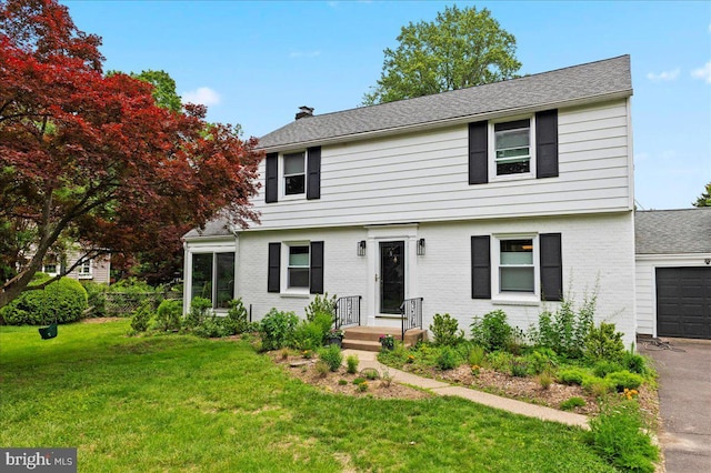 1708 Wrightfield Rd, Yardley, PA 19067 - colonial inspired home with a chimney, brick siding, a front lawn, asphalt driveway, and an attached garage