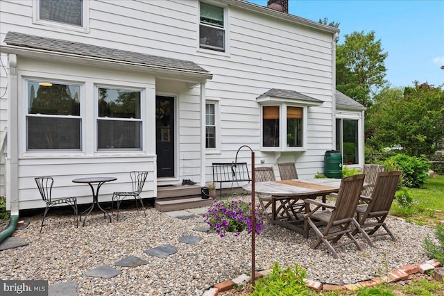 1708 Wrightfield Rd, Yardley, PA 19067 - rear view of house featuring a chimney, outdoor dining space, and a shingled roof