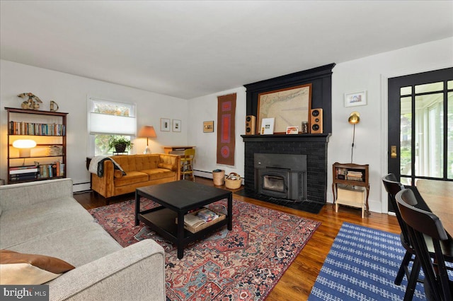 1708 Wrightfield Rd, Yardley, PA 19067 - living room featuring wood finished floors, baseboard heating, a brick fireplace, and a baseboard radiator