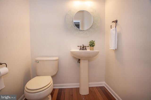 134 Ascot Ct, Bear, DE 19701 - bathroom featuring toilet, wood finished floors, and baseboards