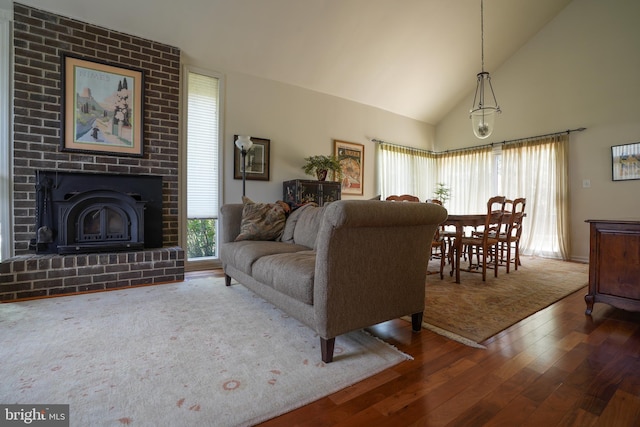 living area featuring high vaulted ceiling and wood-type flooring