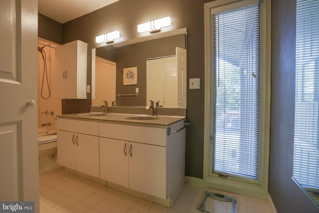 bathroom featuring a sink, tile patterned floors, and double vanity