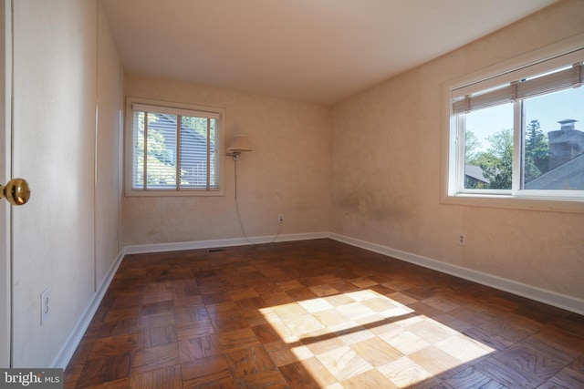 unfurnished room featuring baseboards