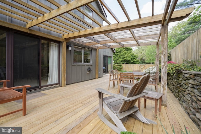wooden terrace featuring a fenced backyard, a pergola, and outdoor dining space
