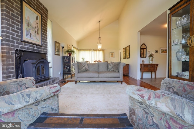 living room with baseboards, wood finished floors, and high vaulted ceiling