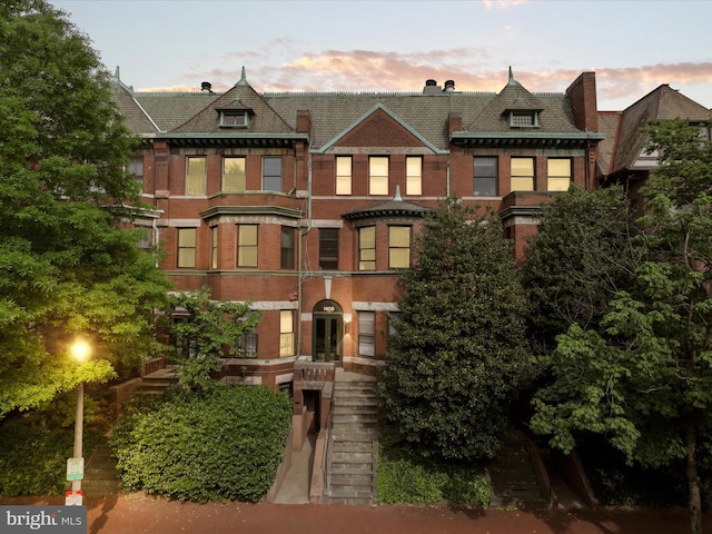 multi unit property featuring brick siding, french doors, and stairway