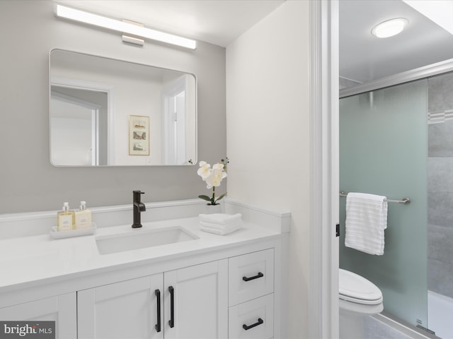 full bathroom with vanity, a stall shower, and toilet