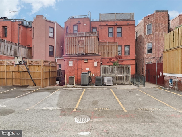 exterior space with central AC and uncovered parking