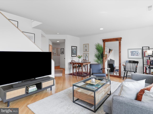 living area with stairway, light wood-style floors, recessed lighting, and visible vents