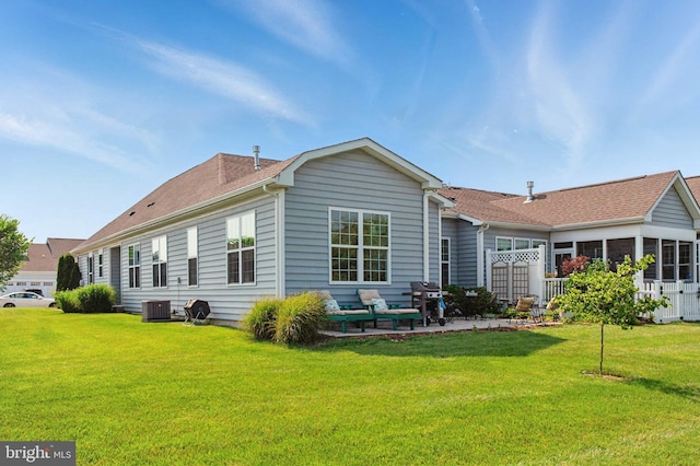 912 Moorings Cir Unit 8, Stevensville, MD 21666 - back of property featuring a yard, central AC, and roof with shingles