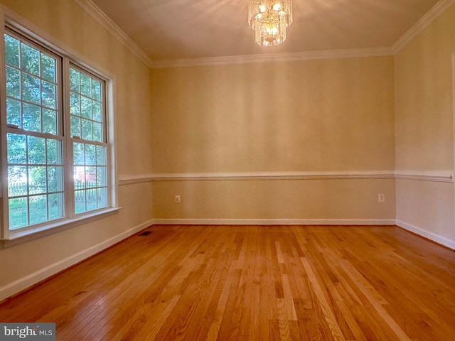 17129 6th St, King George, VA 22485 - unfurnished room with baseboards, a notable chandelier, a wealth of natural light, and hardwood / wood-style flooring