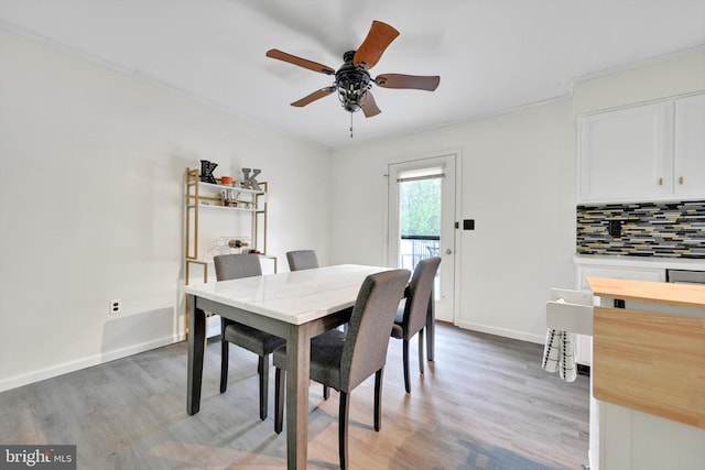 dining room featuring ceiling fan, light wood-type flooring, and baseboards