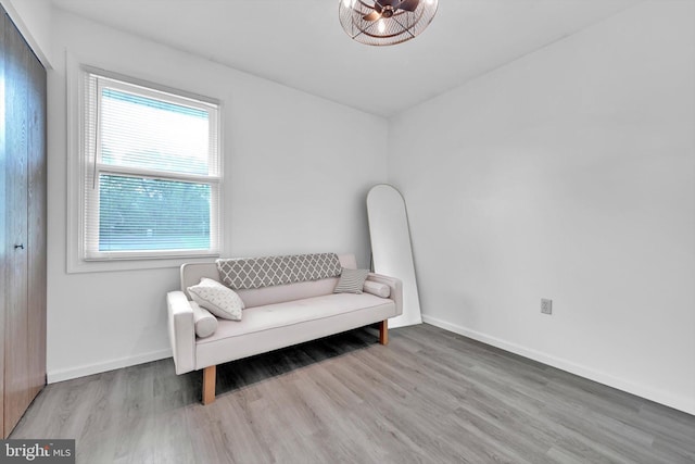 living area featuring wood finished floors and baseboards