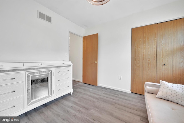 unfurnished office featuring light wood-style flooring and baseboards