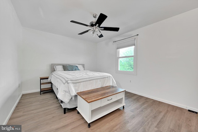bedroom with baseboards, light wood-type flooring, and ceiling fan