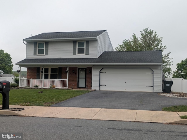 traditional-style home featuring covered porch, an attached garage, brick siding, driveway, and a front yard
