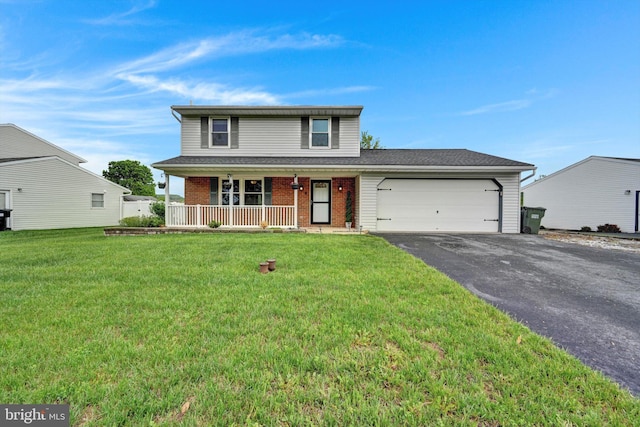 traditional home featuring a porch, asphalt driveway, an attached garage, brick siding, and a front lawn