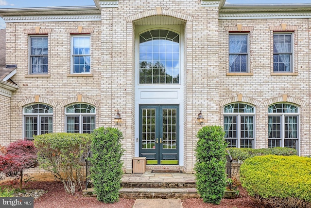 doorway to property with french doors and brick siding