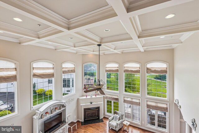 sunroom / solarium featuring beam ceiling and coffered ceiling