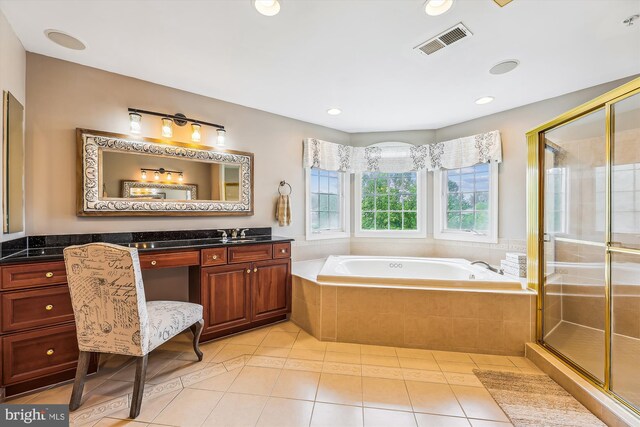 bathroom with a garden tub, a shower stall, tile patterned flooring, and vanity