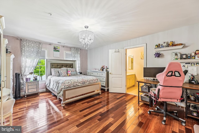 bedroom featuring a chandelier, hardwood / wood-style flooring, and ensuite bathroom
