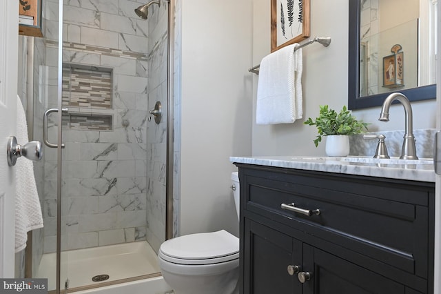 full bath with toilet, a shower stall, and vanity
