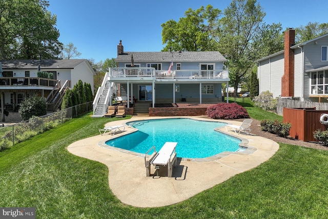 rear view of house featuring stairs, a patio area, a yard, and a deck