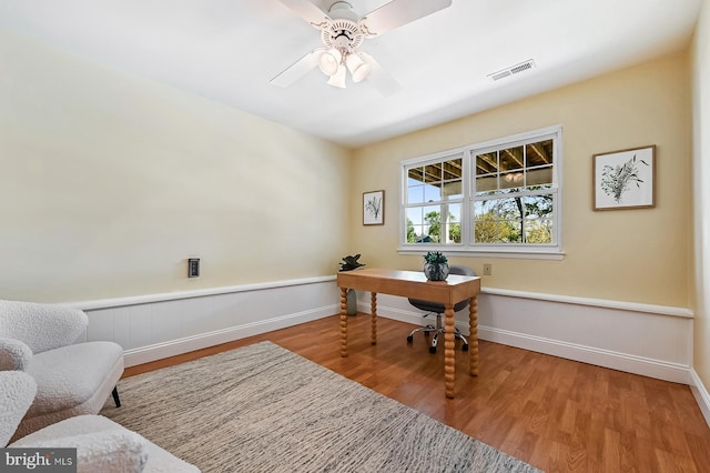 office area with ceiling fan, baseboards, visible vents, and wood finished floors