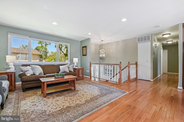 living room with baseboards, recessed lighting, hardwood / wood-style floors, and visible vents