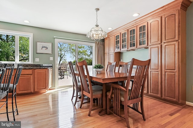 dining room featuring light wood-style floors, baseboards, recessed lighting, and a notable chandelier