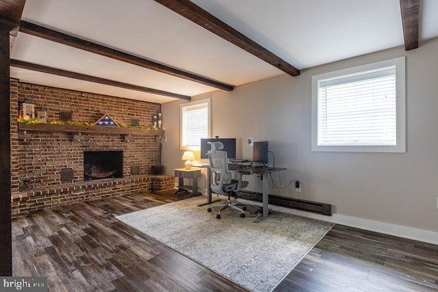 office space featuring baseboards, brick wall, a brick fireplace, wood finished floors, and beamed ceiling