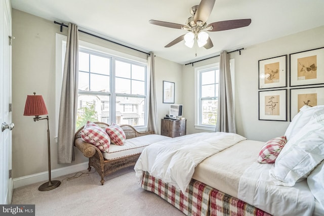 carpeted bedroom featuring baseboards and a ceiling fan