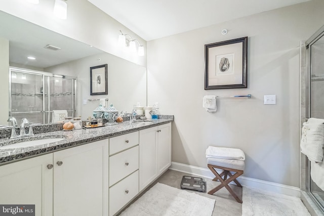 full bath with baseboards, visible vents, a sink, and a stall shower