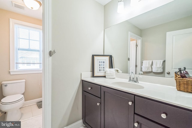 bathroom with visible vents, baseboards, tile patterned floors, vanity, and toilet