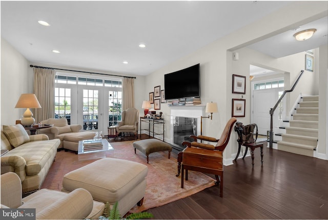 living room with stairway, baseboards, a glass covered fireplace, recessed lighting, and dark wood-type flooring
