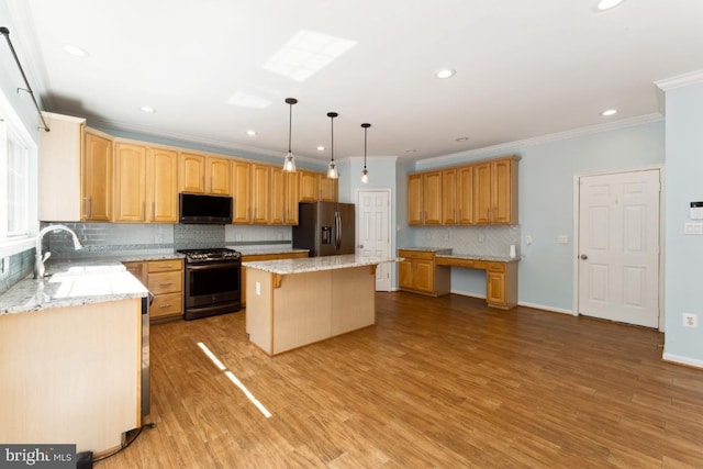 15533 Pamplin Pipe Ct, Manassas, VA 20112 - kitchen featuring appliances with stainless steel finishes, tasteful backsplash, crown molding, a kitchen island, and light stone countertops
