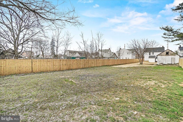 view of yard with a residential view and a fenced backyard