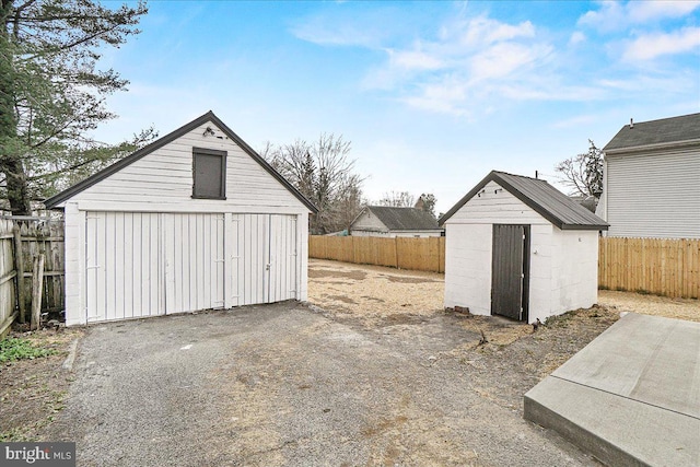 exterior space with fence and a shed