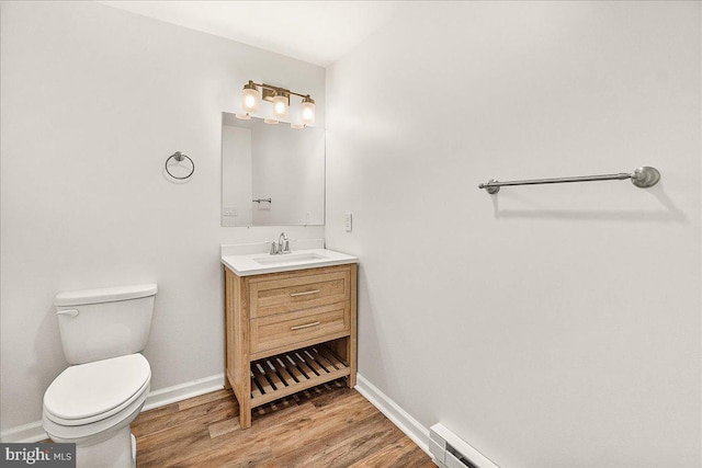 bathroom with vanity, baseboards, toilet, and wood finished floors