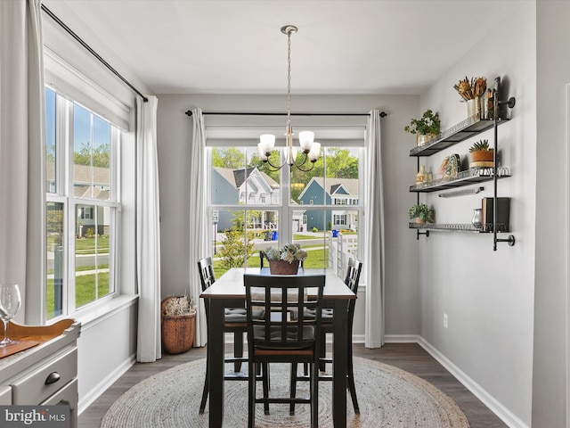 20515 Anchor Ln, Frankford, DE 19945 - dining space featuring baseboards, an inviting chandelier, a healthy amount of sunlight, and dark wood-type flooring