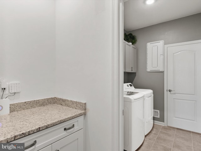 20515 Anchor Ln, Frankford, DE 19945 - laundry room featuring visible vents, washing machine and dryer, electric panel, cabinet space, and light tile patterned floors