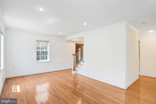 spare room with crown molding, stairs, baseboards, recessed lighting, and light wood-style flooring