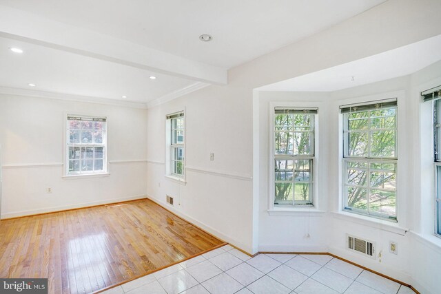 9239 Sand Creek Ct, Burke, VA 22015 - empty room with crown molding, baseboards, visible vents, and light wood-style flooring
