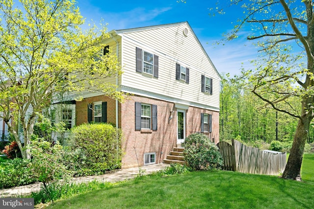 9239 Sand Creek Ct, Burke, VA 22015 - view of front facade featuring brick siding, fence, and a front yard