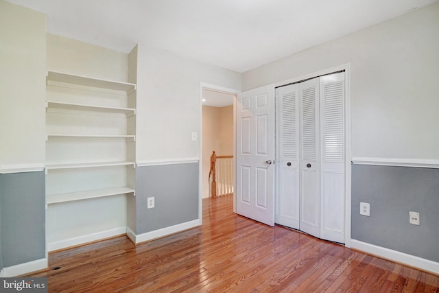 9239 Sand Creek Ct, Burke, VA 22015 - unfurnished bedroom with baseboards, wood finished floors, and a closet