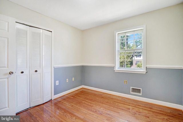 9239 Sand Creek Ct, Burke, VA 22015 - unfurnished bedroom featuring visible vents, baseboards, wood finished floors, and a closet