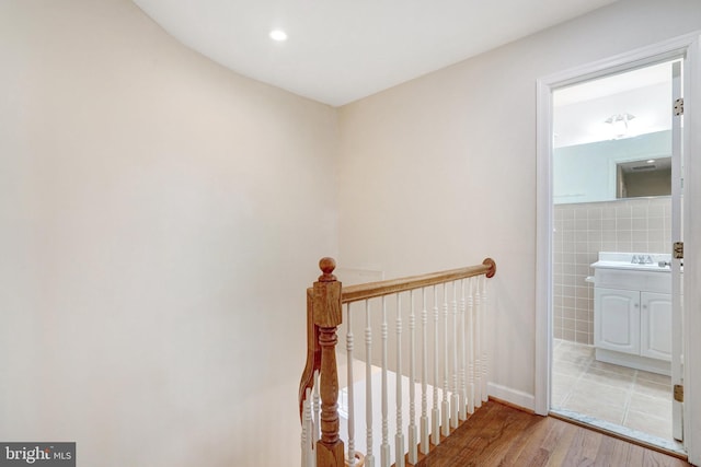 stairs featuring wood finished floors
