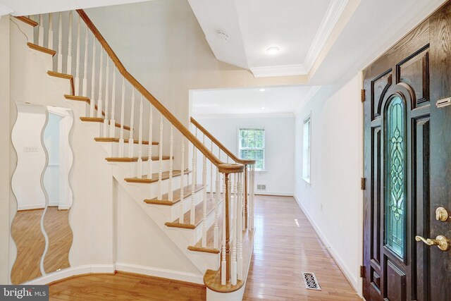 9239 Sand Creek Ct, Burke, VA 22015 - entryway with crown molding, baseboards, visible vents, and wood finished floors